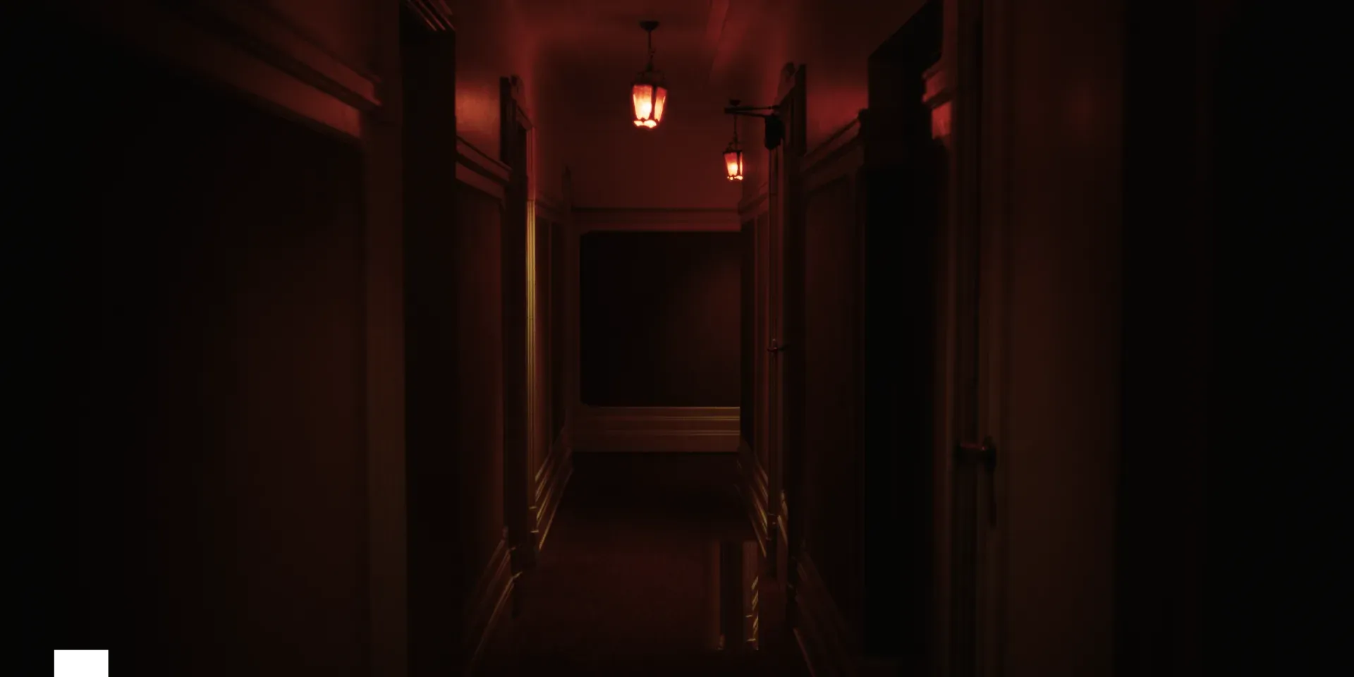 An empty hallway lit in red in The Tears of Things