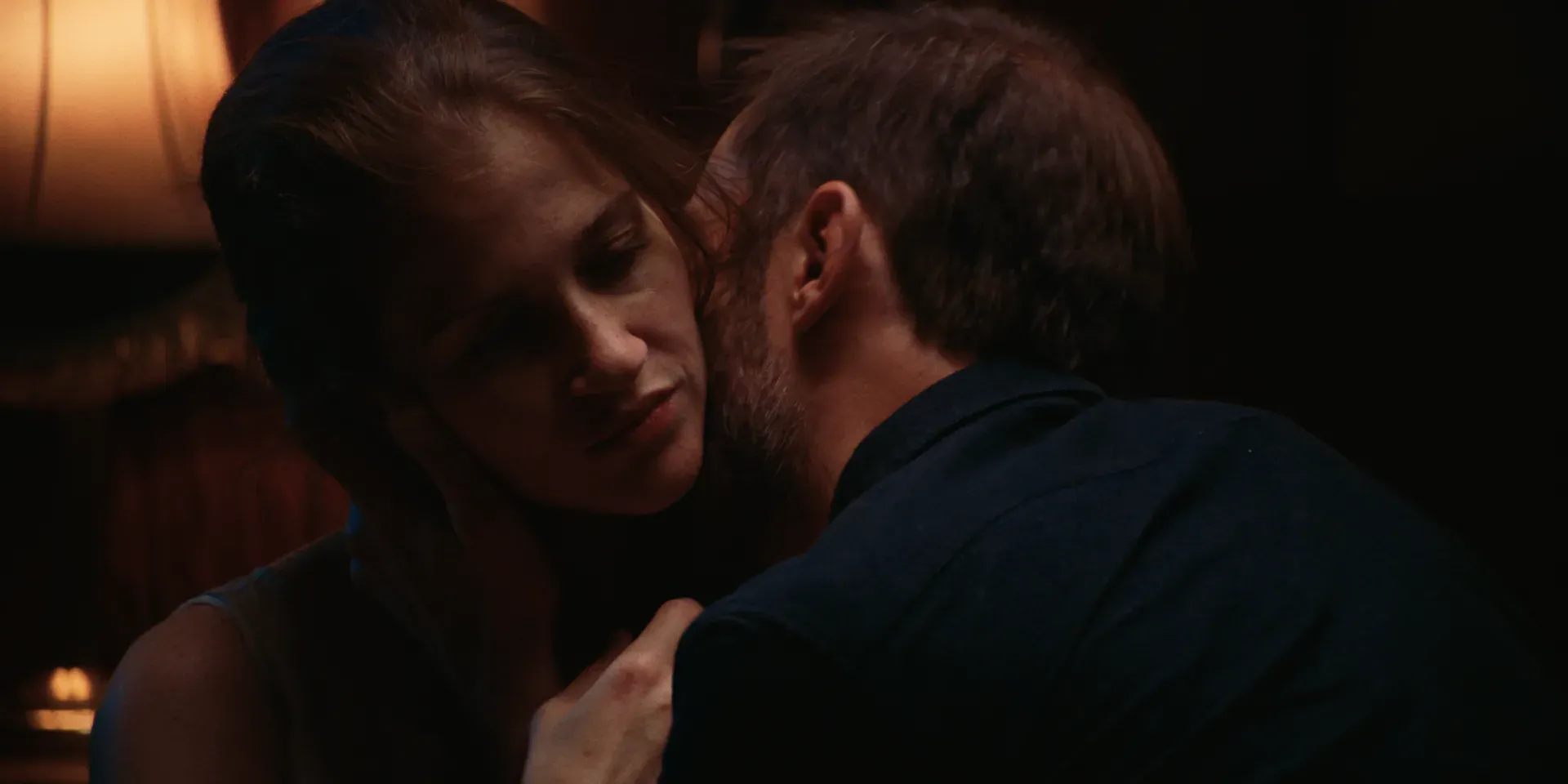 Ana and her husband embracing in warm light in The Tears of Things